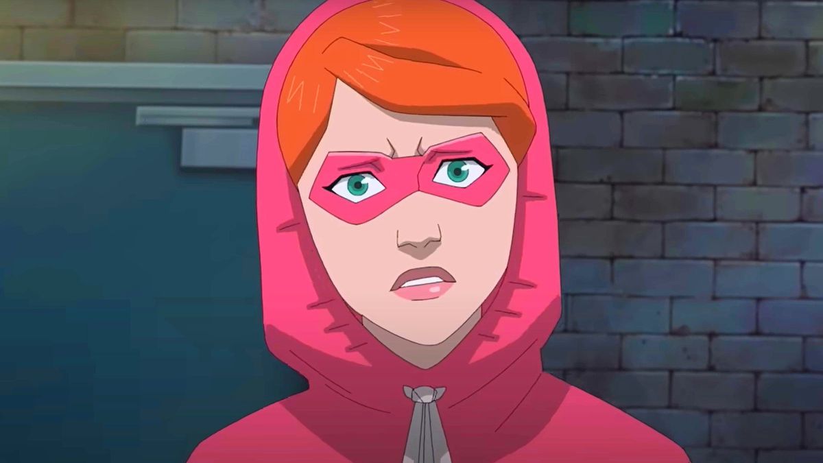 A young Atom Eve, wearing a pink hoodie and mask that covers her eyes, looks puzzled in Invincible: Atom Eve