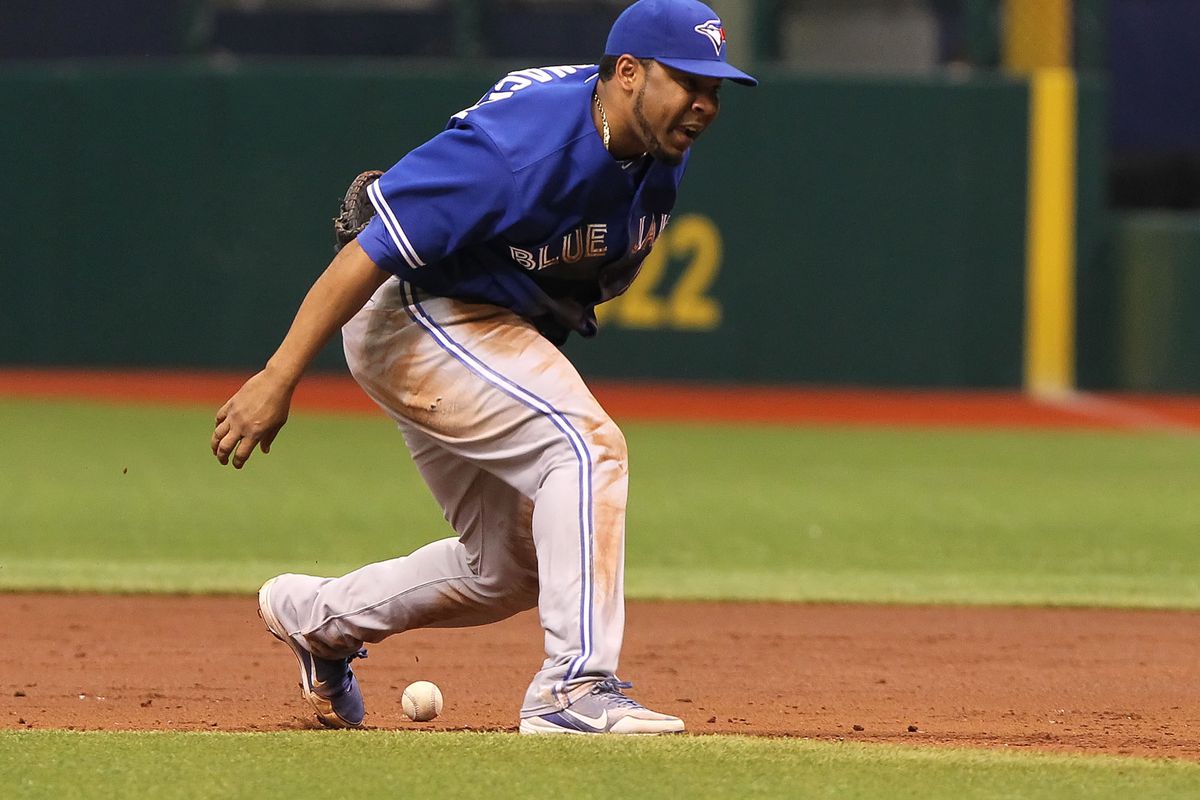 August 9, 2012; St. Petersburg, FL, USA; Toronto Blue Jays first baseman Edwin Encarnacion (10) reacts after he misses the ground ball in the second inning against the Tampa Bay Rays at Tropicana Field. Mandatory Credit: Kim Klement-US PRESSWIRE