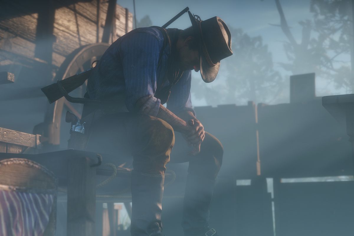 Red Dead Redemption 2 - Arthur sits by his wagon, contemplating what he has done