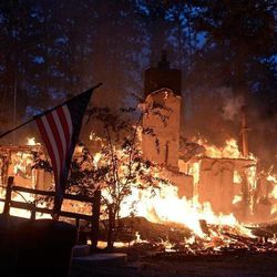 A house is fully engulfed with flames in the midst of the Black Forest Fire northeast of Colorado Springs, Colo., on Wednesday, June 12, 2013.
