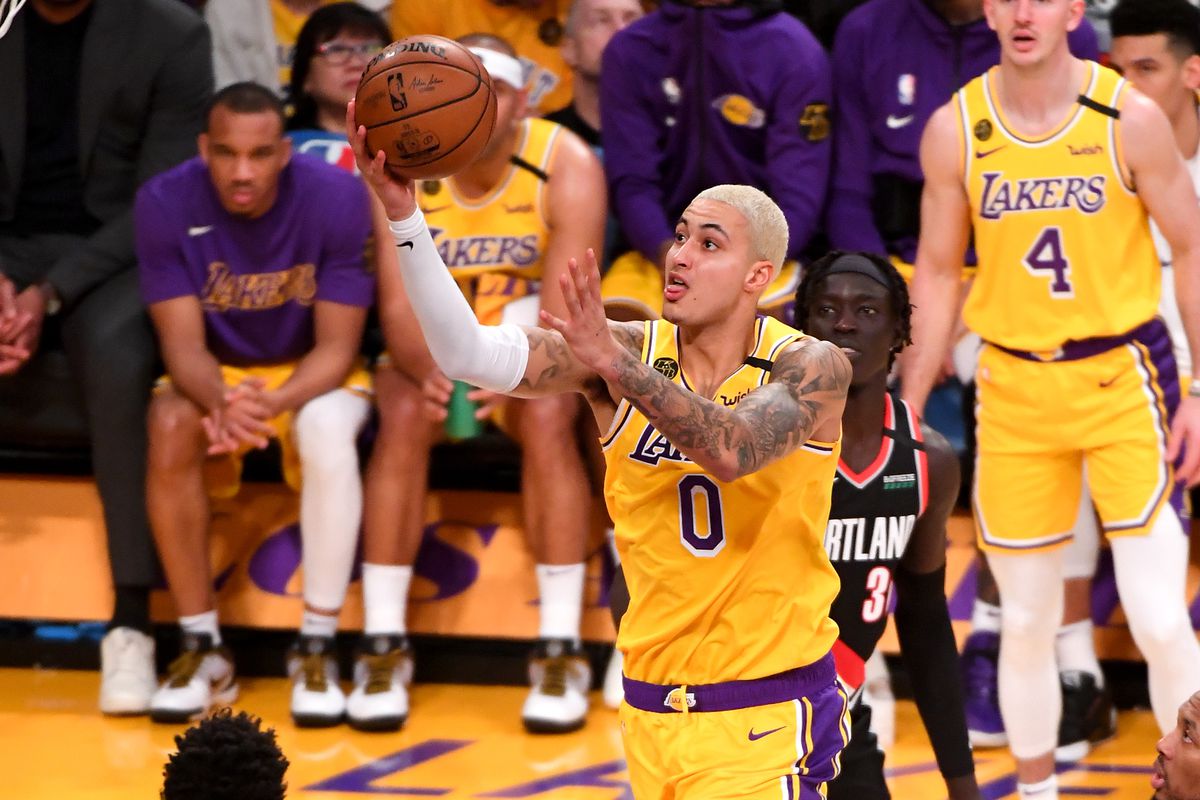 Los Angeles Lakers forward Kyle Kuzma moves to the basket past Portland Trail Blazers guard CJ McCollum in the first half of the game at Staples Center.