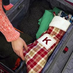 Brittany Copeland packs a stocking full of gifts into her suitcase for a flight to Detroit at her home in Salt Lake City on Thursday, Dec. 22, 2016.  AAA estimates more than 7.6 million Mountain West residents will take a trip out of town for the holidays.