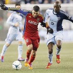 Real's Javier Morales tries to outrun Kansas City's Lawrence Olum with the ball as Real Salt Lake and Sporting KC play Saturday, Dec. 7, 2013 in MLS Cup action. Sporting KC won in a shootout.