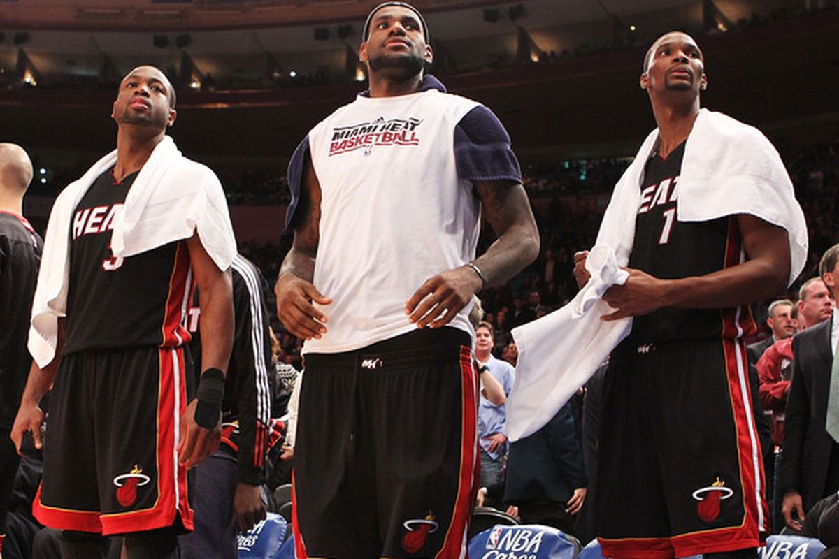 Dwyane Wade, LeBron James and Chris Bosh of the Miami Heat look on during their 113-91 win against the New York Knicks at Madison Square Garden on December 17 2010 in New York City. 