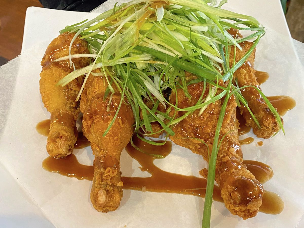 Plate of fried chicken topped with green onions