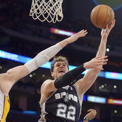 San Antonio Spurs center Tiago Splitter, right, of Brazil, shoots as Los Angeles Lakers forward Pau Gasol, of Spain, defends during the first half of their NBA basketball game, Sunday, April 14, 2013, in Los Angeles. 