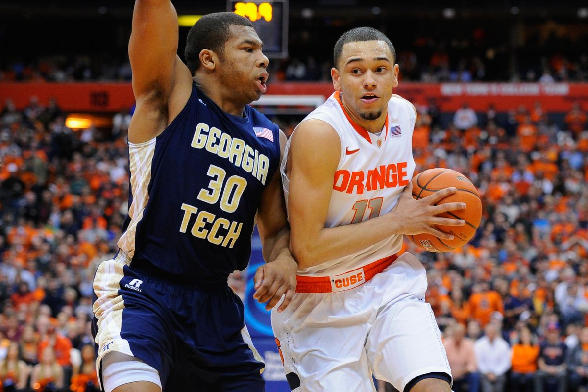 Mar 4, 2014; Syracuse, NY, USA; Georgia Tech Yellow Jackets forward Kammeon Holsey (24) looks to shoot the ball with Syracuse Orange forward C.J. Fair (5) defending during the first half of a game at the Carrier Dome. Georgia Tech won the game 67-62