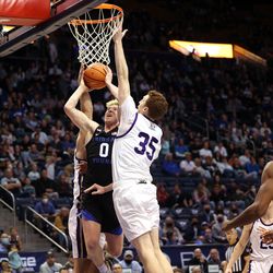 Brigham Young Cougars guard Hunter Erickson (0) goes to the hoop with Westminster Griffins forward Ryan Bell (35) defending as BYU and Westminster play at the Marriott Center in Provo on Wednesday, Dec. 29, 2021. BYU won 65-53.