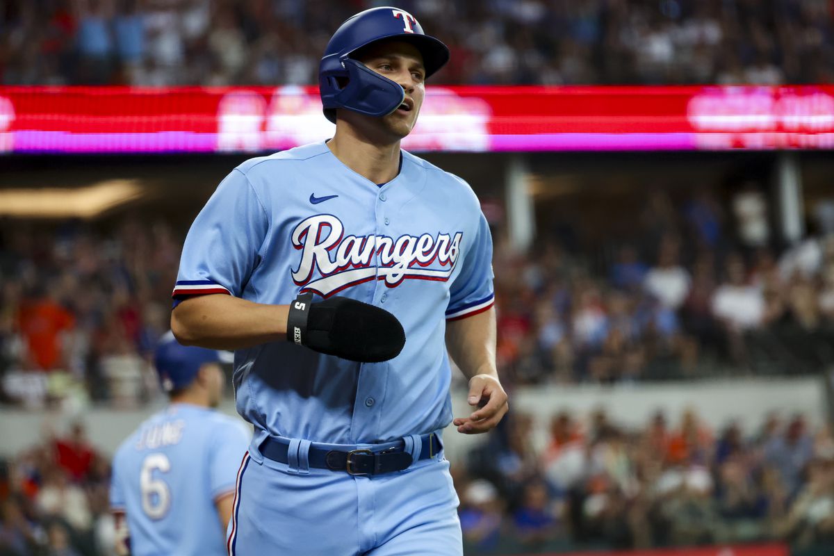 Jul 2, 2023; Arlington, Texas, USA; Texas Rangers shortstop Corey Seager (5) reacts after scoring a run during the first inning against the Houston Astros at Globe Life Field.