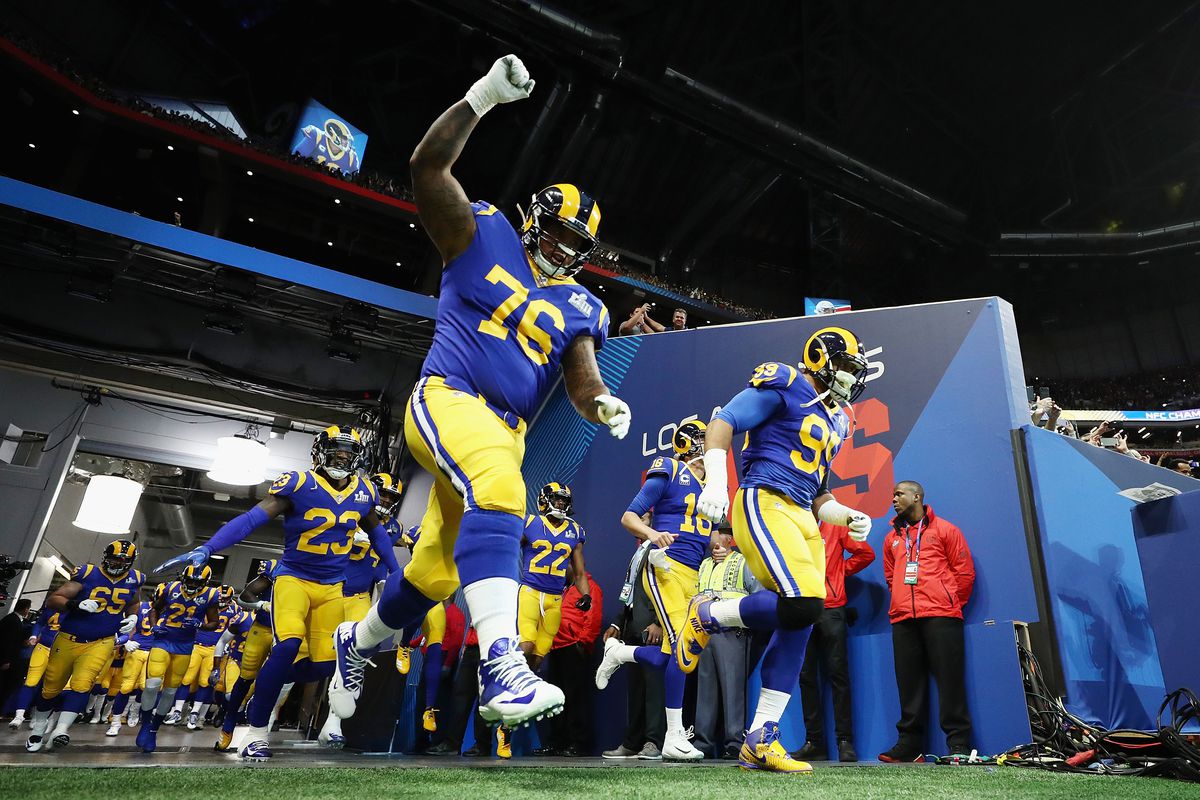 Los Angeles Rams LG Rodger Saffold leaps onto the field prior to Super Bowl LIII, Feb. 3, 2019.