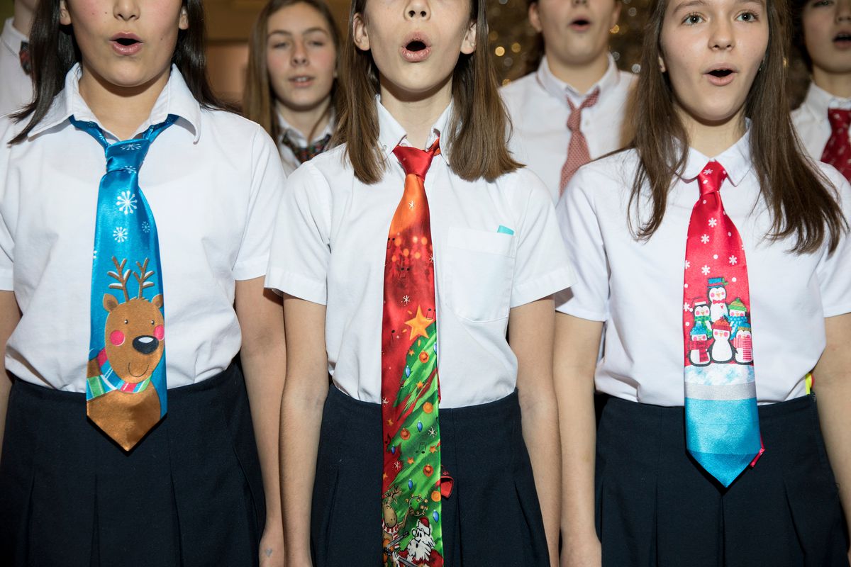 A close-up of children singing, wearing ties, in a Christmas choir at Mall of America