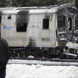Emergency personnel stand near the site of a collision between a Metro-North Railroad train and a SUV in Valhalla, N.Y., Wednesday, Feb. 4, 2015.  Five train passengers and the SUV’s driver were killed in Tuesday evening’s crash in Valhalla, about 20 miles north of New York City. Authorities said the impact was so forceful the electrified third rail came up and pierced the train.  