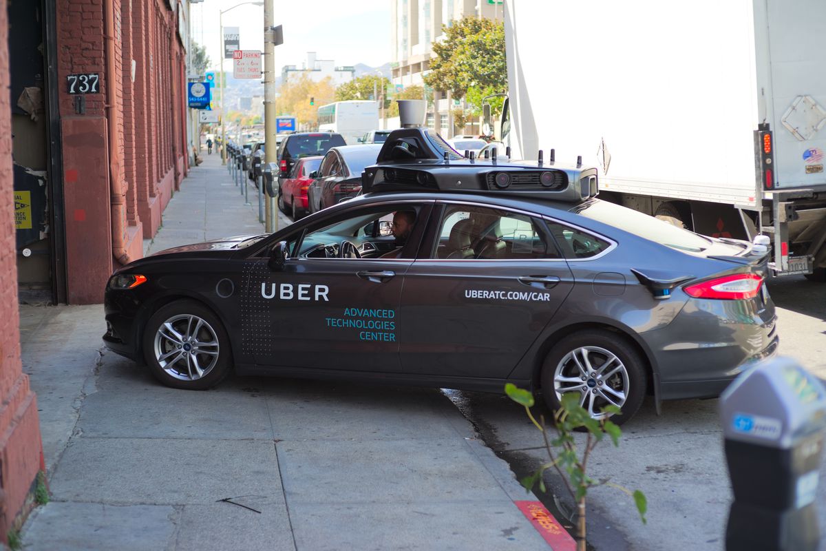 A self-driving Uber car pulling out of the garage.