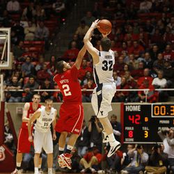 BYU's Jimmer Fredette shoots over Chris Kupets to score at the end of the first half as the University of Utah and BYU play men's basketball Tuesday, Jan. 11, 2011, in Salt Lake City.