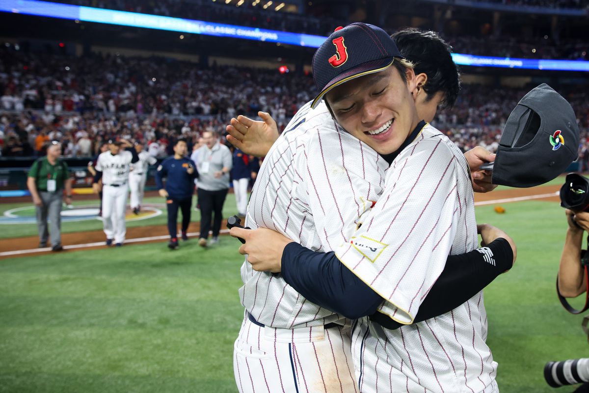 Shohei Ohtani #16 and Yoshinobu Yamamoto #18 of Team Japan celebrate after winning the 2023 World Baseball Classic Championship game over Team USA at loanDepot Park on Tuesday, March 21, 2023 in Miami, Florida.