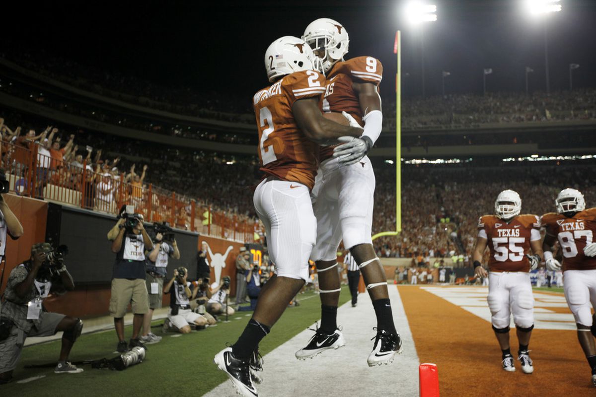 AUSTIN, TX - SEPTEMBER 3:  Flying was already dangerous enough, but Texas running back Fozzy Whittaker just had to try and take a teammate along, didn't he? (Photo by Erich Schlegel/Getty Images)