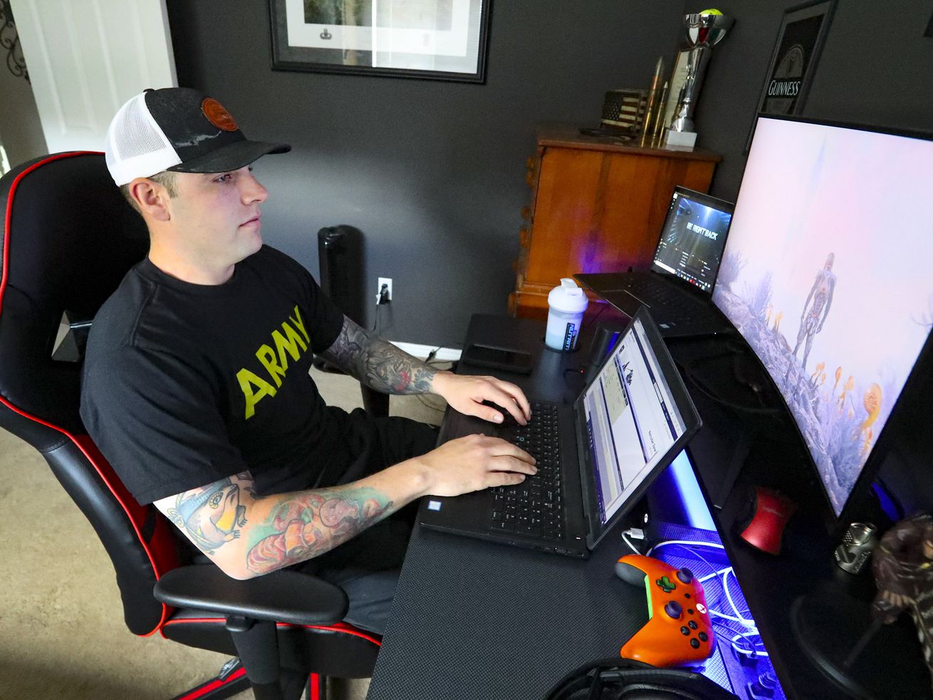 U.S. Army recruiter Staff Sgt. Garret Richard works on his laptop from his home in Pleasant Grove on Thursday, April 23, 2020.