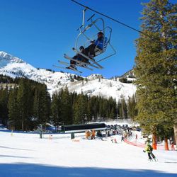 Skiers ride one of the lifts Sunday, Feb. 8, 2015, at Brighton Ski Resort as they enjoy the warm temperatures.