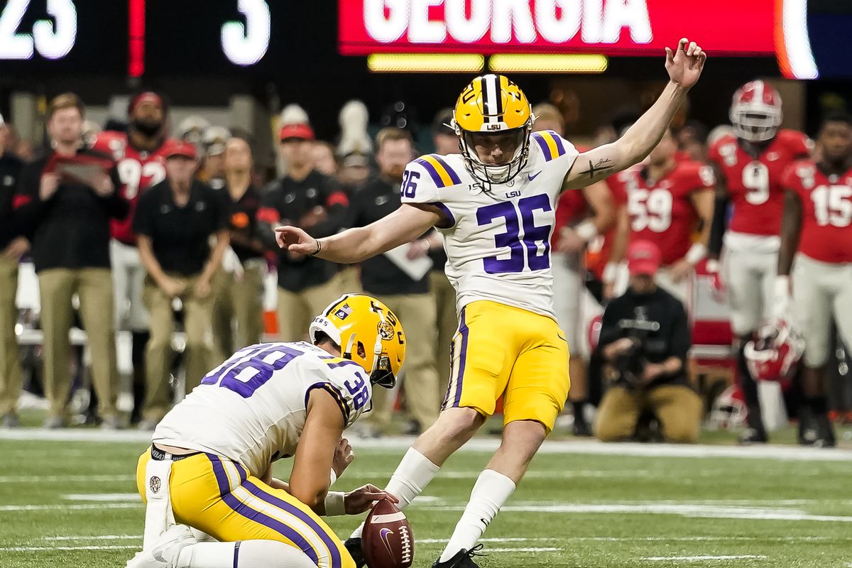 Cade York #36 kicks a field goal from the hold of Clyde Townsend #28 of the LSU Tigers during a game between Georgia Bulldogs and LSU Tigers at Mercedes Benz Stadium on December 7, 2019 in Atlanta, Georgia.