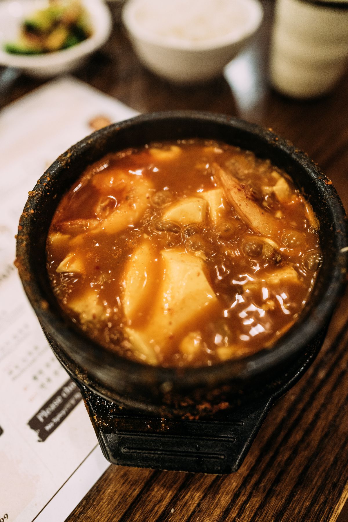A close photo of a small bowl of soft tofu jjigae Korean stew.