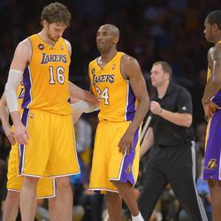 Los Angeles Lakers guard Kobe Bryant, right, is helped off the court by forward Pau Gasol, of Spain, after being injured during the second half of their NBA basketball game against the Golden State Warriors, Friday, April 12, 2013, in Los Angeles. The Lakers won 118-116. (AP Photo/Mark J. Terrill)