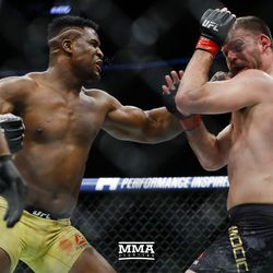 Francis Ngannou connects with a left at UFC 220.