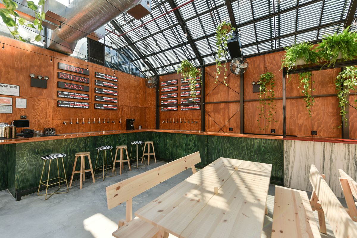 The green bar inside Evil Twin Brewing’s greenhouse brewery