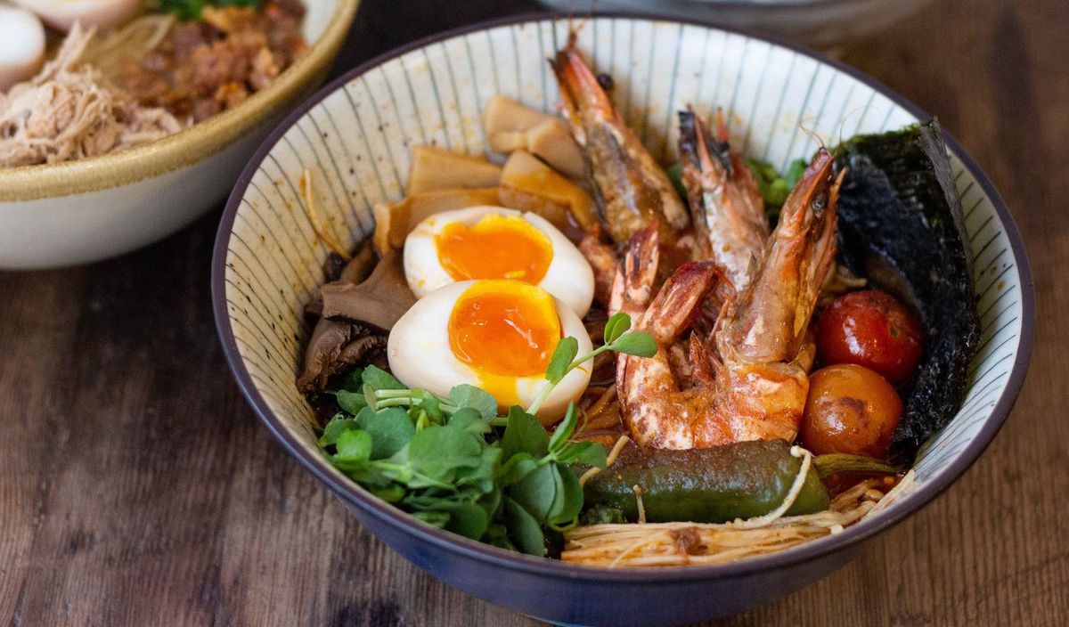 A bowl of Filipino-Japanese ramen with prawns and an egg at Ramo Ramen Kentish Town