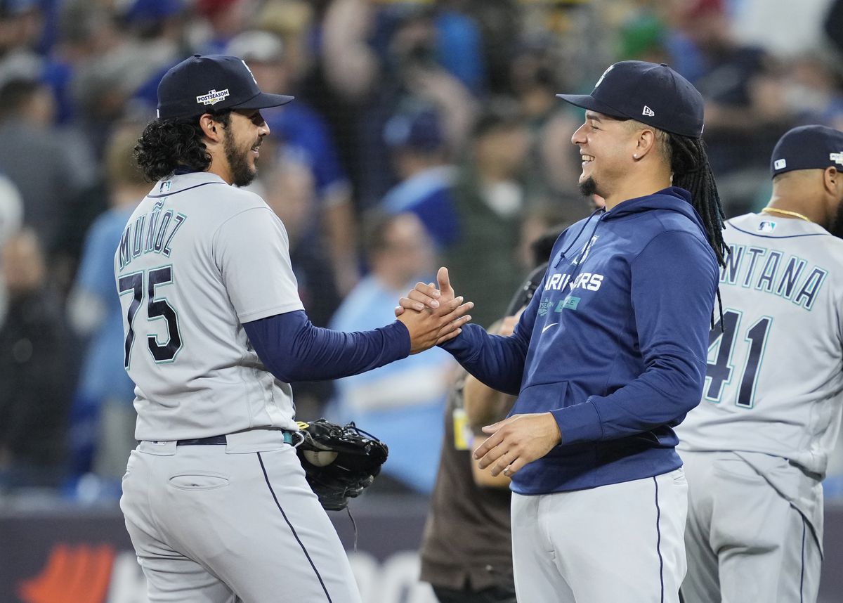 Luis Castillo #21 of the Seattle Mariners (R) celebrates with Andres Munoz #75 after their team defeated the Toronto Blue Jays in Game One of their AL Wild Card series at Rogers Centre on October 7, 2022 in Toronto, Ontario, Canada.