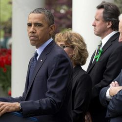 President Barack Obama frowns as he speaks during a news conference in the Rose Garden of the White House, in Washington, on Wednesday, April 17, 2013, about a bill to expand background checks on guns that was defeated in the Senate. He is joined by former Rep. Gabby Giffords, second from left, Vice President Joe Biden, and Newtown family members from left, Neil Heslin, father of Jesse Lewis; and Mark Barden. 
