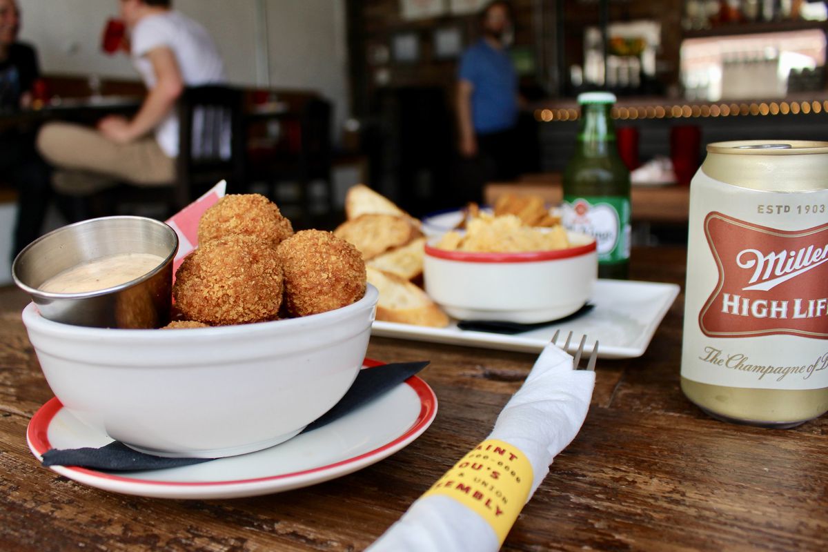 Lou’s Backyard features hushpuppies with schmaltzy Tabasco sauce. 