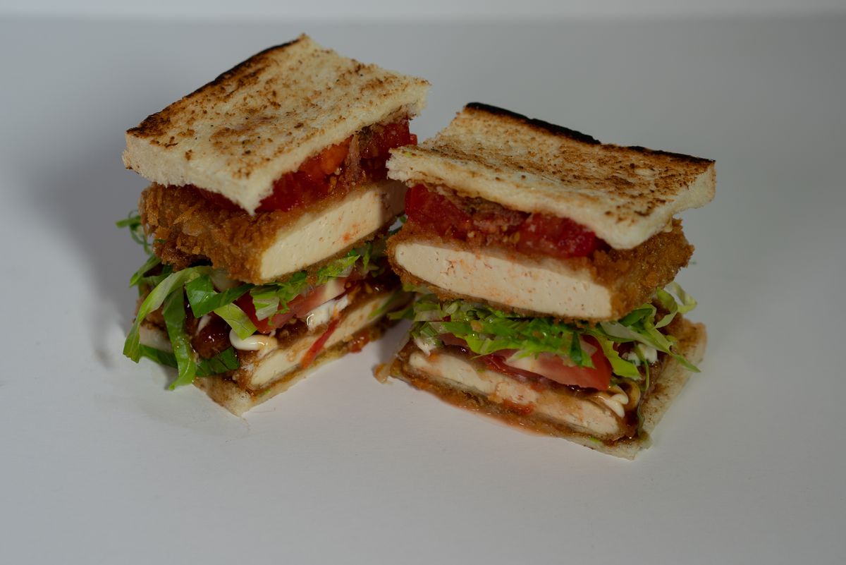A tall sandwich made with tofu.