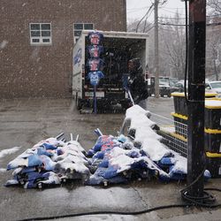 9:49 a.m. Souvenir vendor shaking the snow off of the t-shirts, and packing up