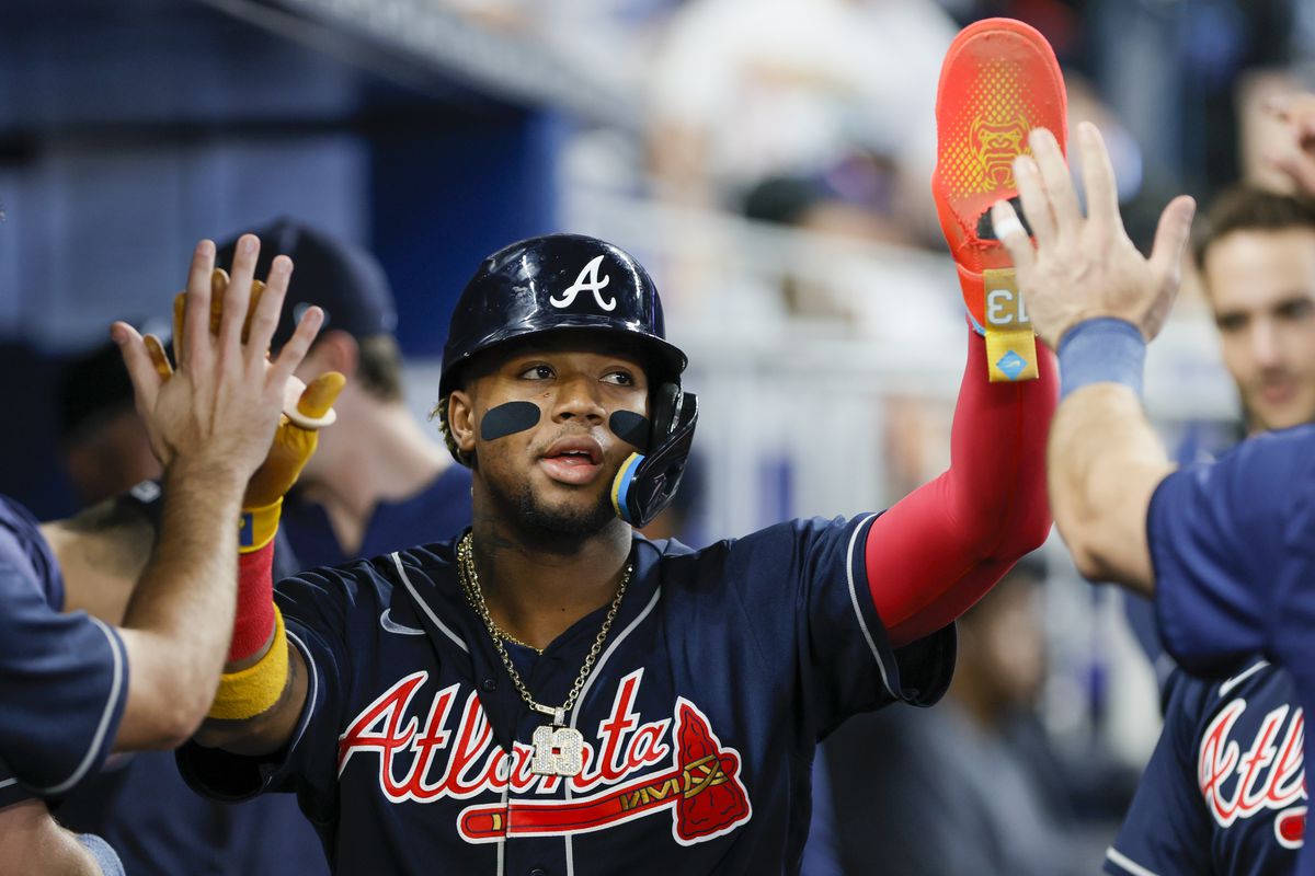 Ronald Acuna Jr. #13 of the Atlanta Braves celebrates with teammates after scoring against the Miami Marlins during the first inning at loanDepot park on May 04, 2023 in Miami, Florida.