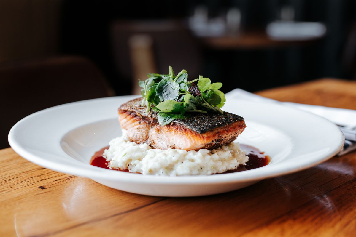 Seared salmon atop creamed fennel and walnut sauce from Adele’s, opening in Atlanta, GA, 2022.