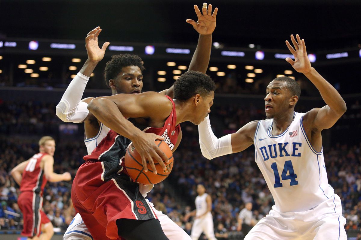 Nov 22, 2014; Brooklyn, NY, USA; Stanford Cardinal guard Anthony Brown (21) is defended by Duke Blue Devils forward Justise Winslow (12) and guard Rasheed Sulaimon (14) during the first half at Barclays Center. 