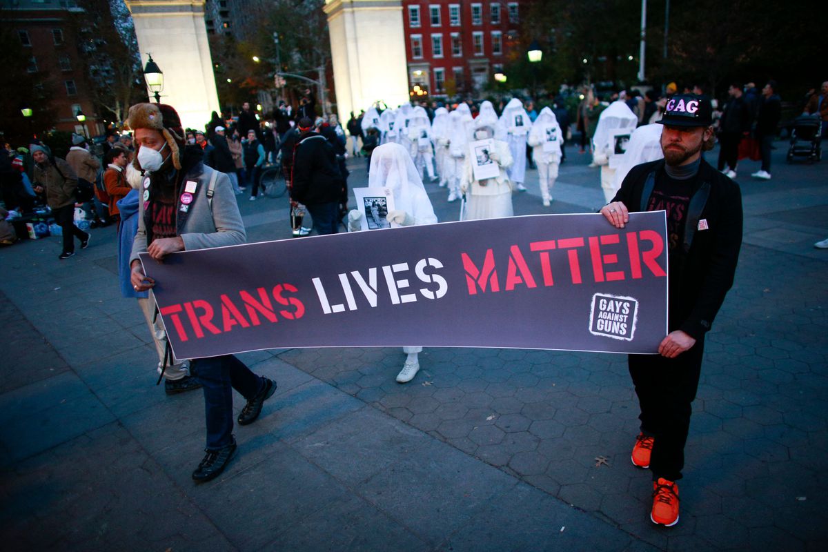 Marchers hold a “Trans Lives Matter” banner honoring transgender victims of violence on Transgender Day of Remembrance in Washington Square Park in New York on Nov. 20, 2021.