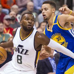 Utah guard Shelvin Mack (8) gets by Golden State guard Stephen Curry (30) during the first half of an NBA basketball game in Salt Lake City on Thursday, Dec. 8, 2016.