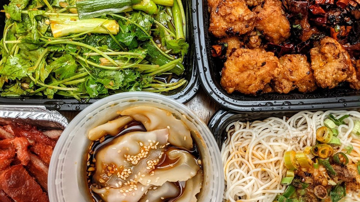 Overhead view of five open takeout containers of Sichuan food, including a cilantro and green pepper salad, dry fried chicken, wontons, noodles, and more.