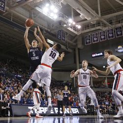 BYU's Kyle Collinsworth (5) shoots against Gonzaga's Bryan Alberts (10), and in front of Domantas Sabonis (11) and Kyle Wiltjer (33) during the first half of an NCAA college basketball game, Thursday, Jan. 14, 2016, in Spokane, Wash. (AP Photo/Young Kwak)