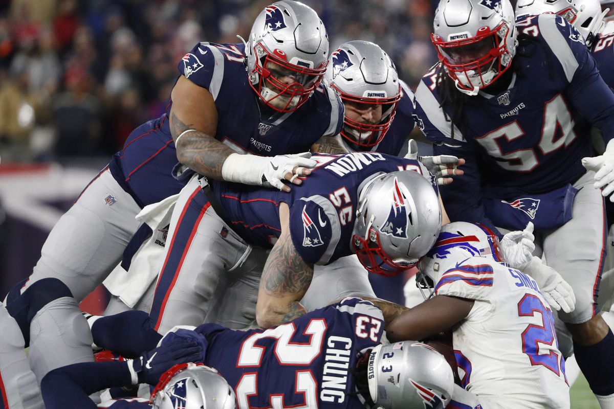 The New England Patriots defense led by defensive end John Simon and strong safety Patrick Chung gang tackle Buffalo Bills running back Devin Singletary during the second half at Gillette Stadium.