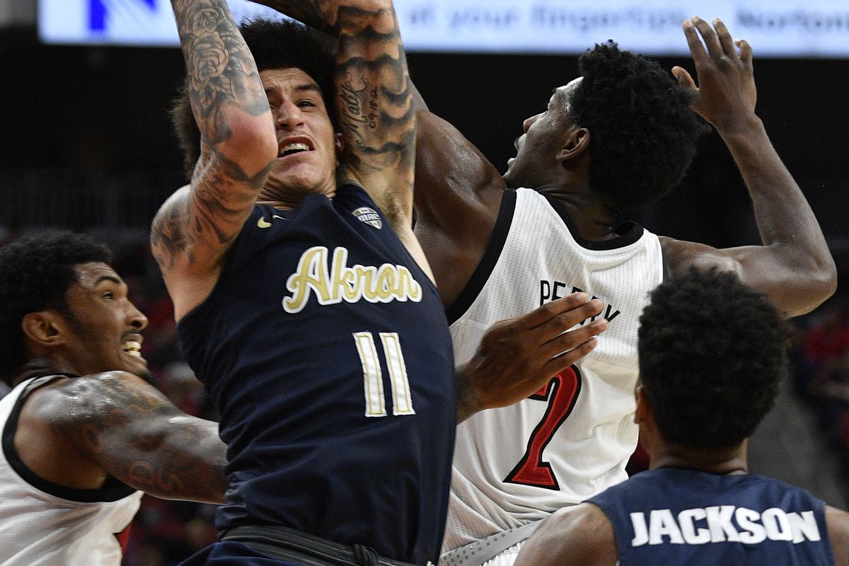 Nov 24, 2019; Louisville, KY, USA; Akron Zips guard Channel Banks battles Louisville Cardinals guard Darius Perry for a rebound during the second half at KFC Yum! Center. Louisville defeated Akron 82-76.