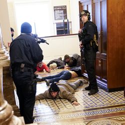U.S. Capitol Police hold rioters at gunpoint near the House chamber inside the U.S. Capitol on Wednesday, Jan. 6, 2021, in Washington.