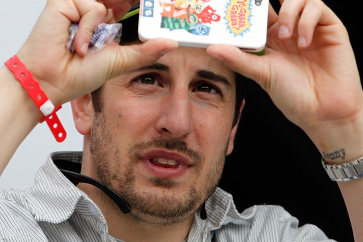FONTANA, CA - MARCH 26:  Actor Jason Biggs takes a photo with his phone during the NASCAR Nationwide Series Royal Purple 300 at Auto Club Speedway on March 26, 2011 in Fontana, California.  (Photo by Tom Pennington/Getty Images)