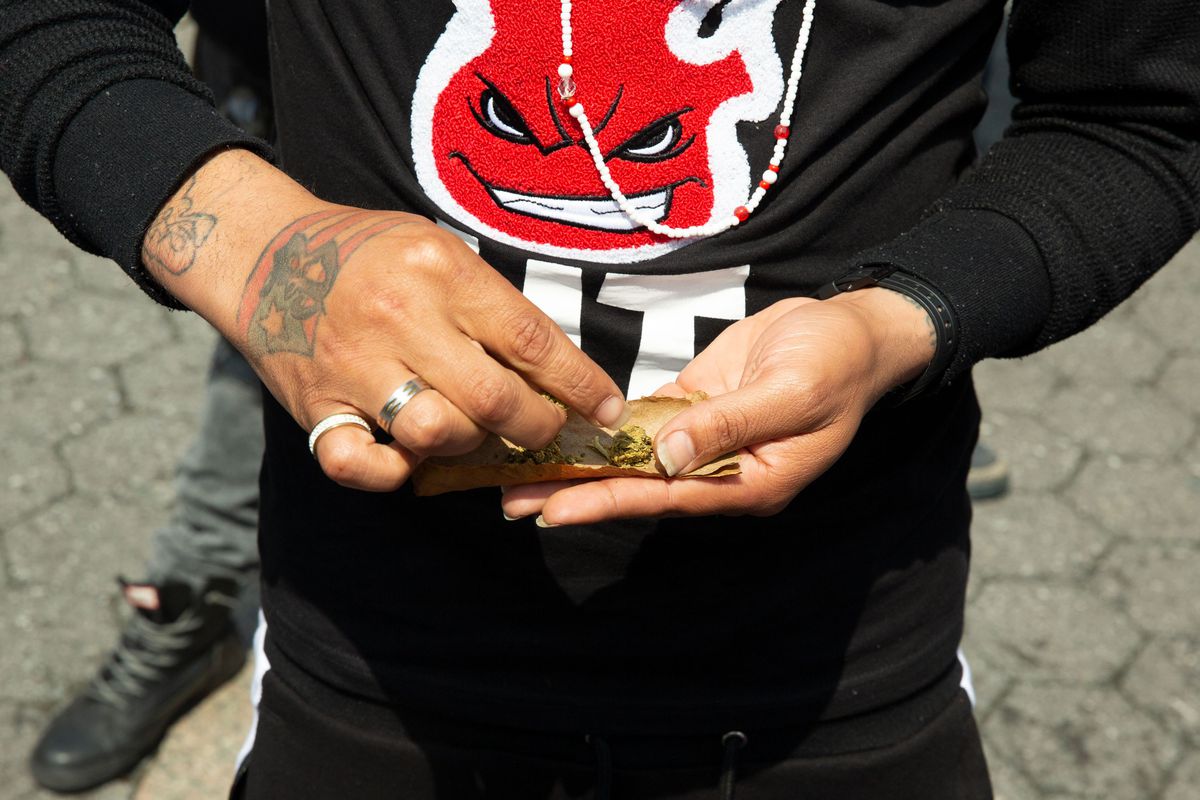 A smoker rolls a joint in Union Square during a rally advocating the legalization of recreational marijuana use, May 4, 2019.