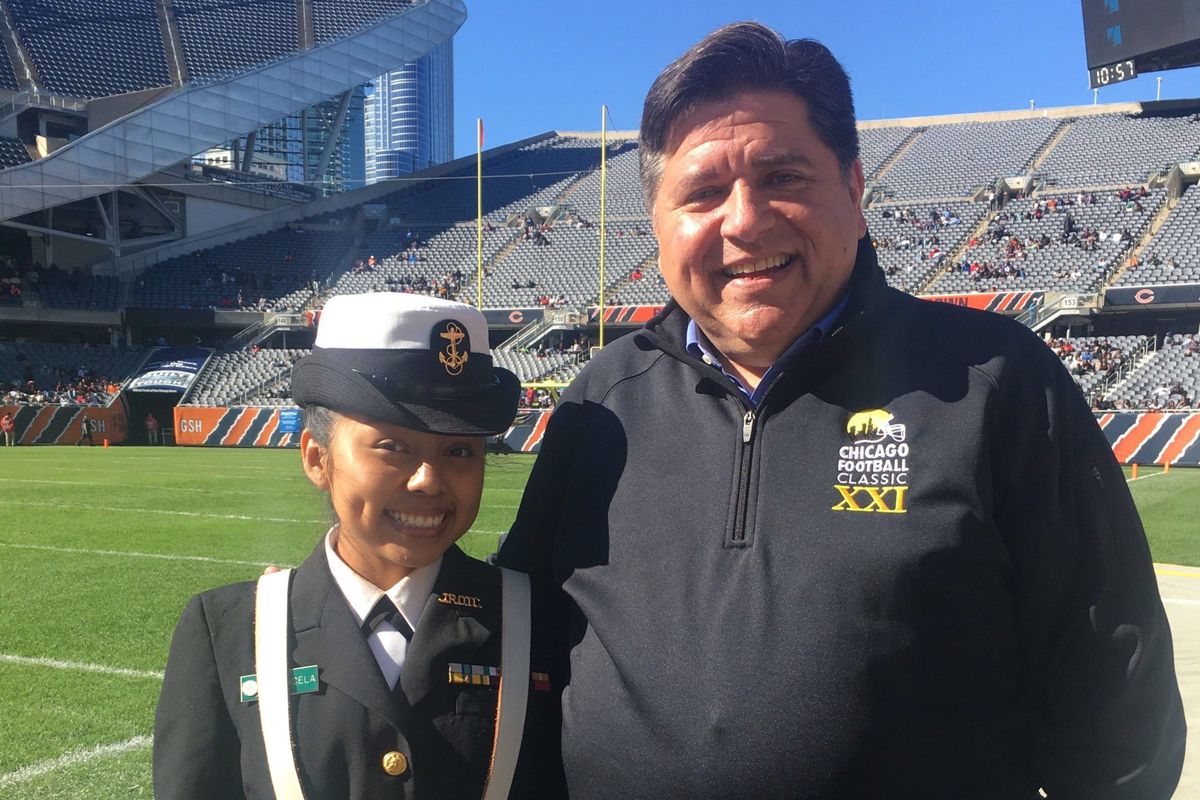 Chicago junior Luz Mayancela posed in 2019 with J.B. Pritzker, now Illinois governor, at Chicago's Soldier Field, where she took part in an ROTC color guard.