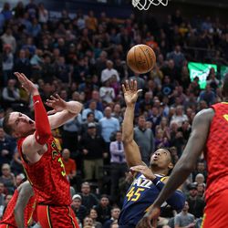 Utah Jazz guard Donovan Mitchell (45) is charged with a foul against Atlanta Hawks forward Tyler Cavanaugh (34) in the final minutes of the game at Vivint Smart Home Arena in Salt Lake City on Tuesday, March 20, 2018.