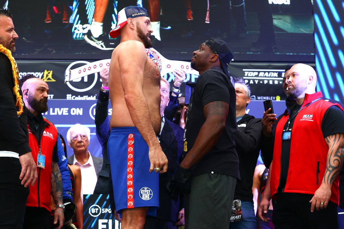 Tyson Fury (L) and Dillian Whyte (R) face-off during the weigh in prior to their WBC heavyweight championship fight at BOXPARK on April 22, 2022 in London, England.
