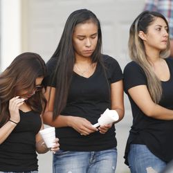 Family and friends gather during a vigil for Natalia Casagrandes in Magna on Thursday, June 2, 2016. Casagrande, 24, was found dead in her home. Police say Jason Alan Black, 27, who had been at the house before to purchase marijuana, showed up unscheduled, shot Casagrande and then tried to kill her 5-year-old daughter by suffocating her with a pillow.