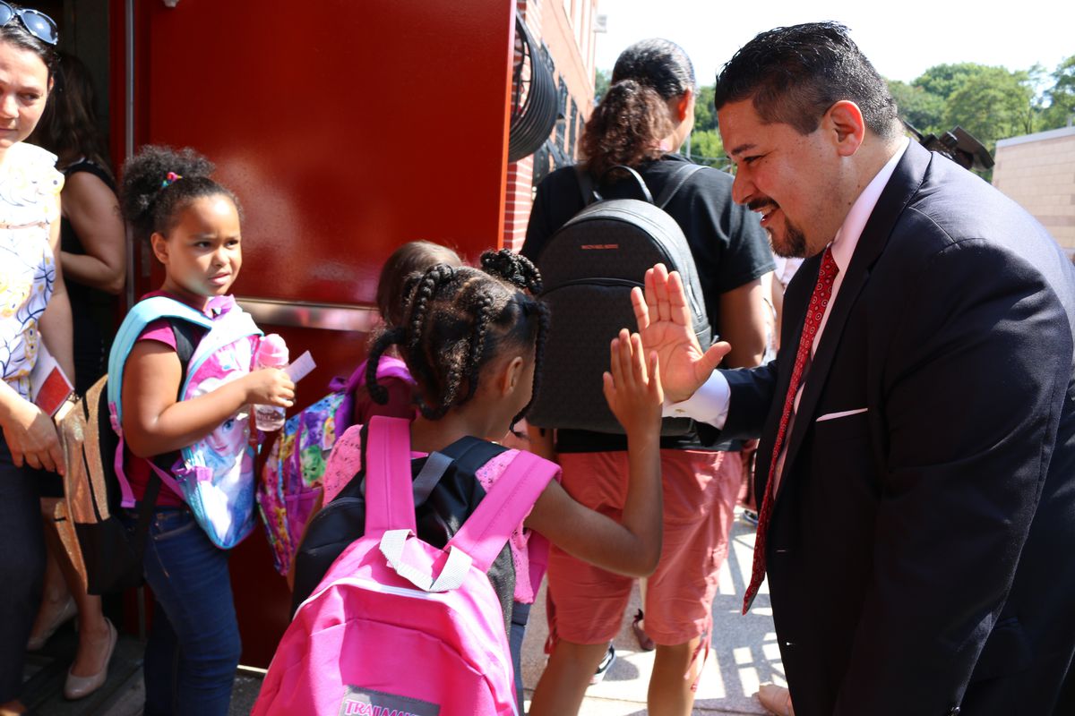 Schools Chancellor Richard Carranza high-fives students at P.S. 78 on Staten Island as they leave after the first day of the 2018-2019 school year.